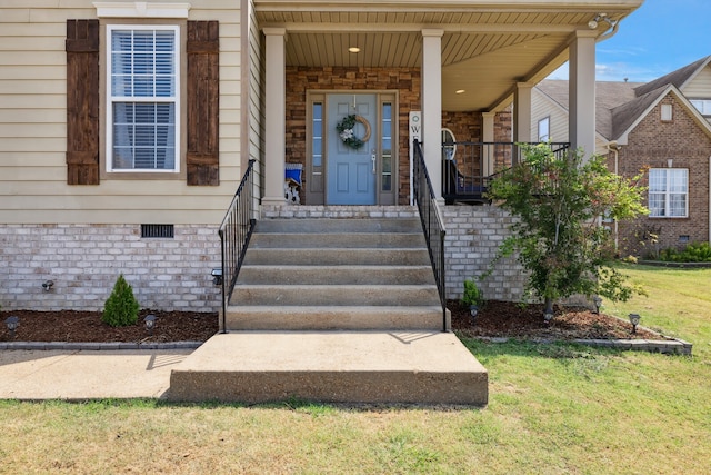 property entrance with a porch and a yard