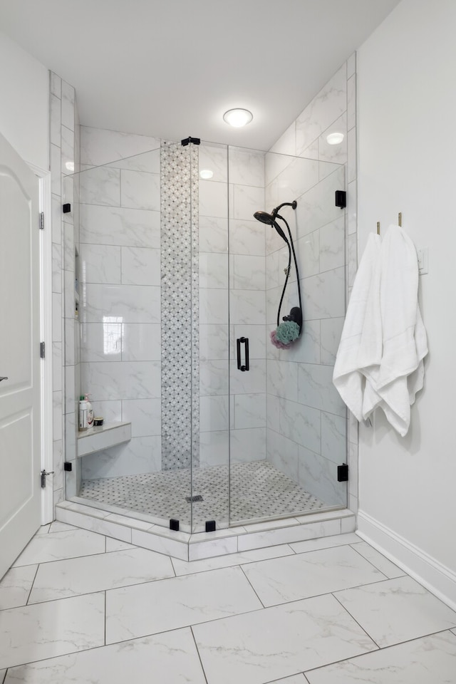 bathroom featuring a shower with shower door