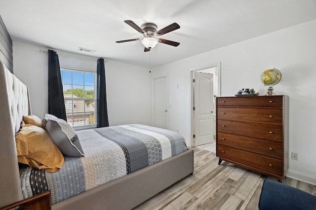 bedroom with ceiling fan and light hardwood / wood-style floors