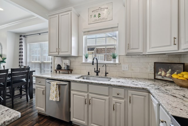 kitchen featuring dishwasher, a wealth of natural light, white cabinetry, and sink