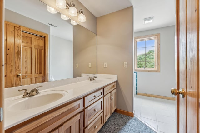 full bathroom featuring double vanity, visible vents, baseboards, and a sink