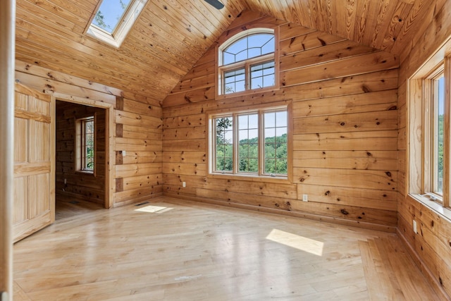 empty room featuring wood walls and light wood-style floors