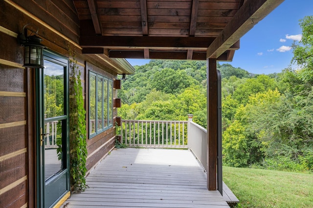 wooden terrace with a view of trees