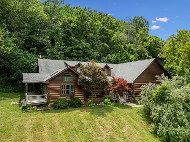 log cabin with a front lawn