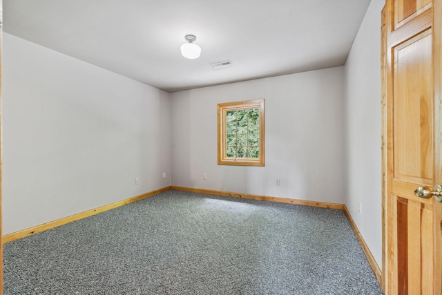 carpeted empty room featuring visible vents and baseboards