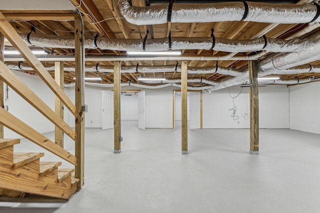 unfinished basement featuring stairs