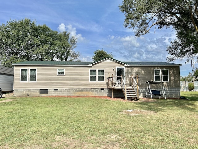 rear view of house featuring a yard and crawl space