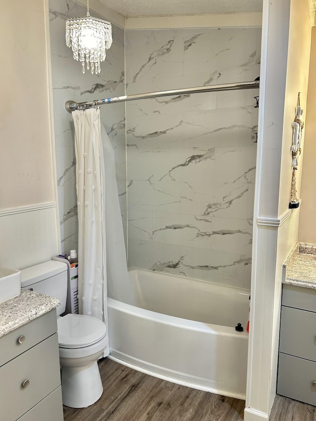 bathroom featuring toilet, shower / tub combo, wainscoting, vanity, and wood finished floors