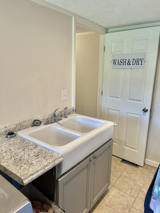 kitchen featuring gray cabinets, light countertops, and a textured ceiling