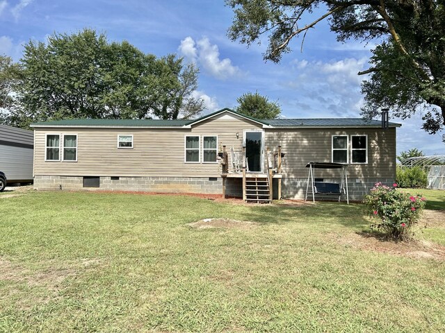 rear view of property with a yard