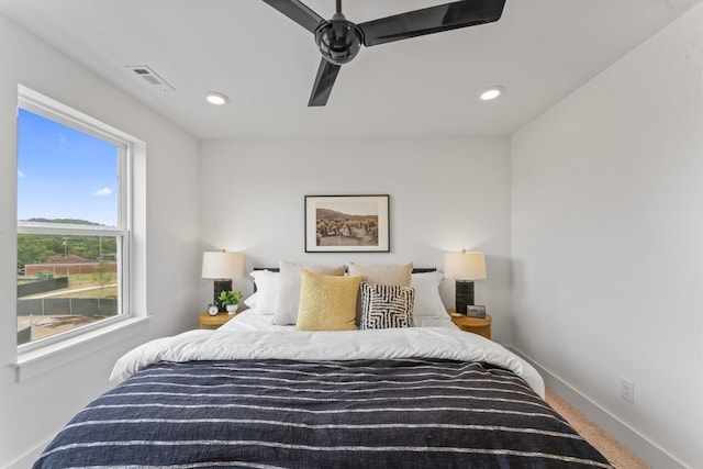 bedroom featuring ceiling fan and carpet