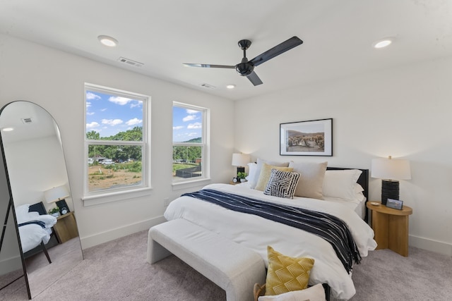 bedroom with light carpet and ceiling fan