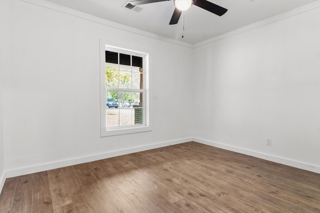 unfurnished room featuring wood-type flooring, ornamental molding, and ceiling fan