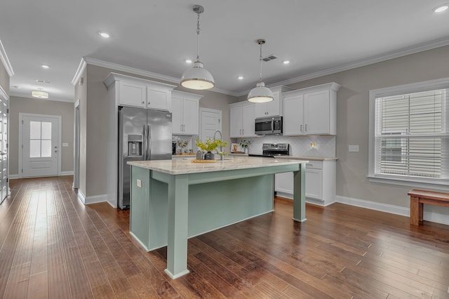 kitchen with dark hardwood / wood-style flooring, stainless steel appliances, and white cabinets