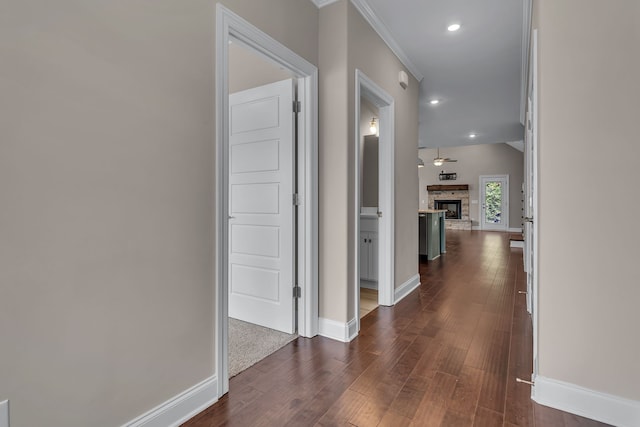 hallway featuring crown molding and dark wood-type flooring