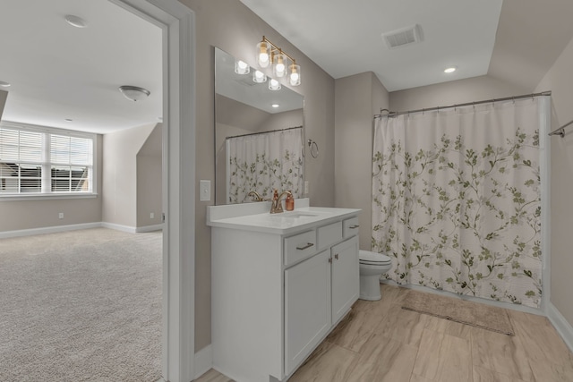 bathroom featuring vanity, toilet, and a shower with shower curtain