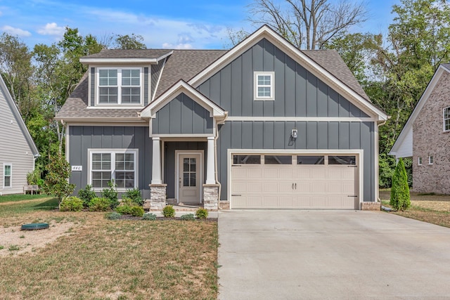 view of front of home with a garage and a front lawn