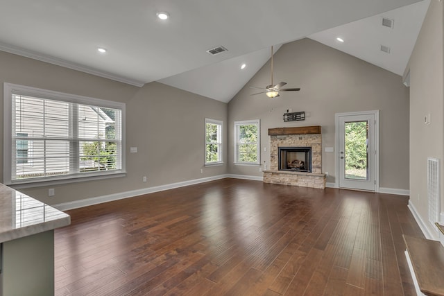 unfurnished living room with a fireplace, a wealth of natural light, ceiling fan, and dark hardwood / wood-style floors