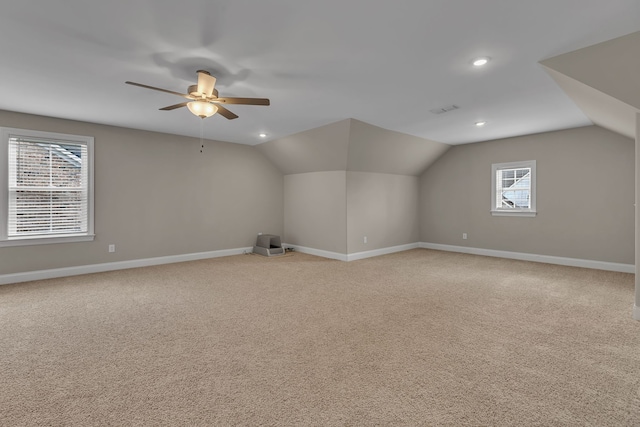 bonus room featuring a wealth of natural light, light colored carpet, ceiling fan, and vaulted ceiling