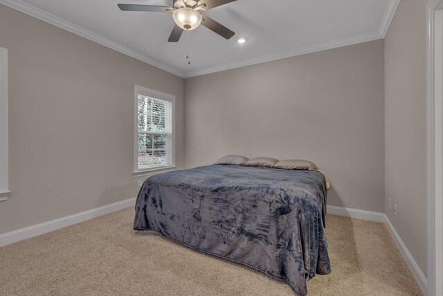 bedroom with ceiling fan, crown molding, and light carpet