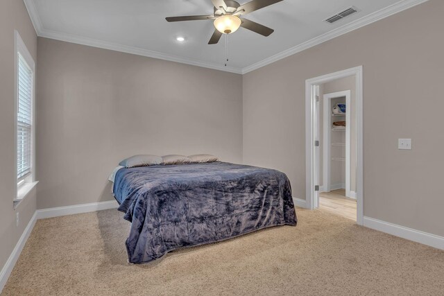 bedroom featuring ceiling fan, crown molding, and carpet floors