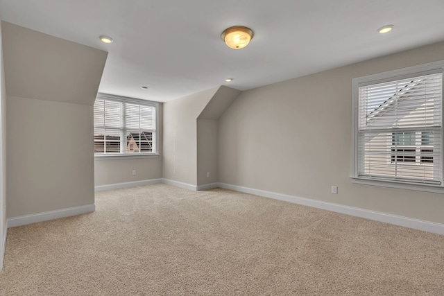 bonus room featuring light colored carpet