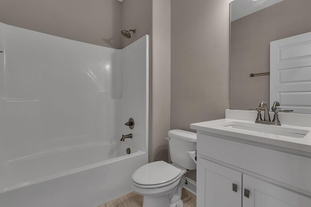 full bathroom with vanity, toilet, washtub / shower combination, and wood-type flooring