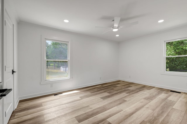 empty room with light wood-type flooring, crown molding, and ceiling fan