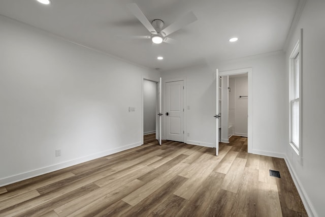 unfurnished bedroom with light hardwood / wood-style flooring, ceiling fan, and ornamental molding