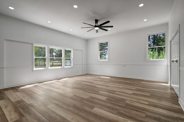 empty room with ceiling fan, hardwood / wood-style flooring, and ornamental molding