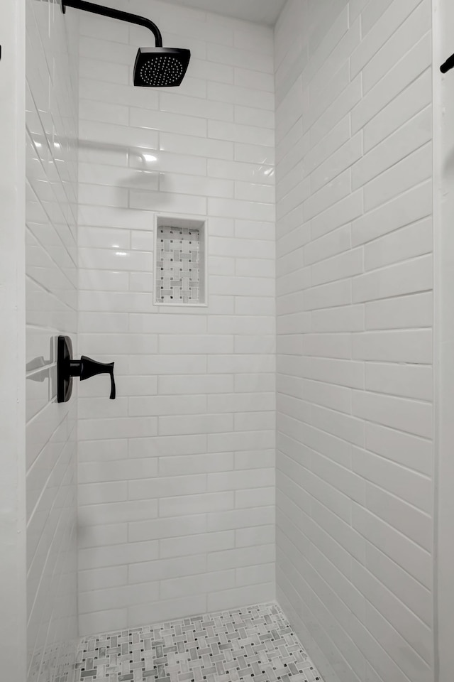 bathroom with a tile shower