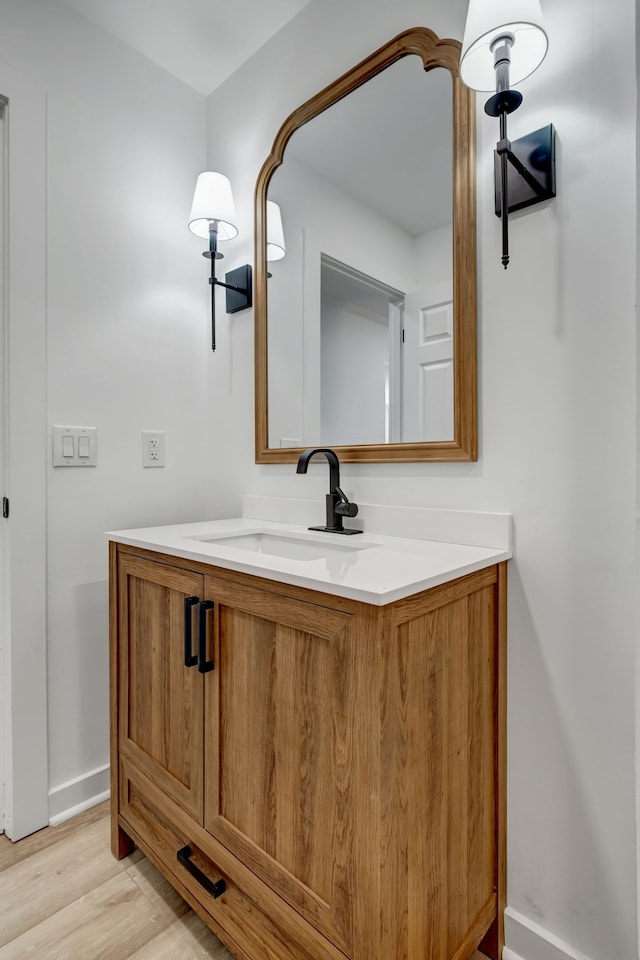 bathroom with vanity and hardwood / wood-style floors