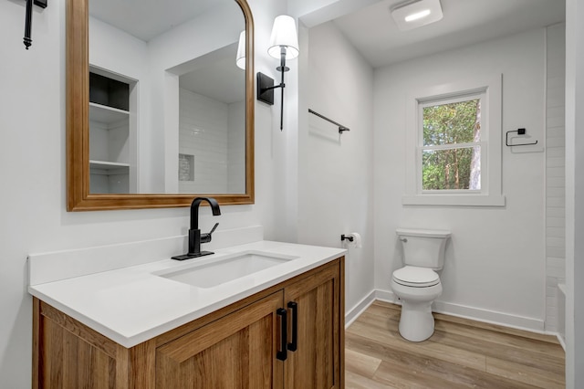 bathroom featuring vanity, toilet, and hardwood / wood-style flooring