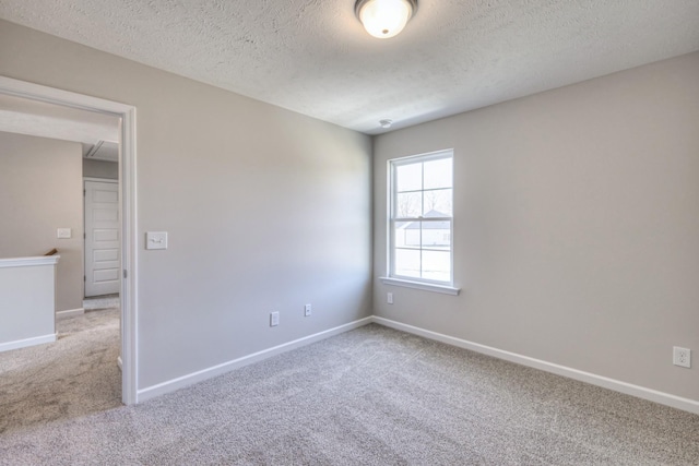 carpeted spare room with a textured ceiling