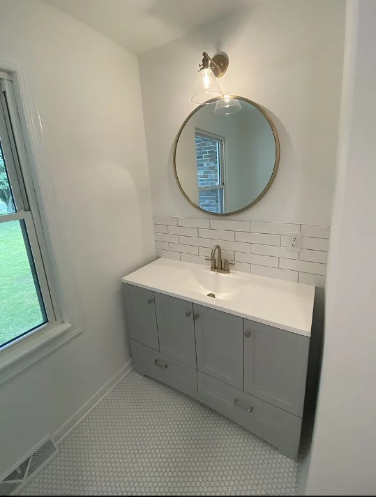 bathroom with tile patterned flooring and vanity