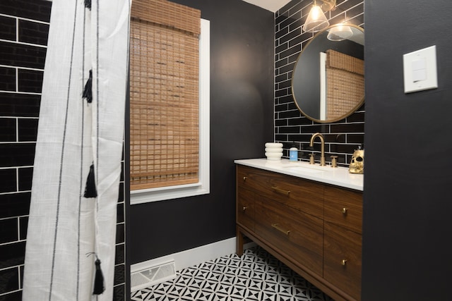 bathroom with tile patterned flooring and vanity