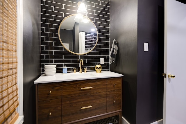 bathroom featuring vanity and backsplash