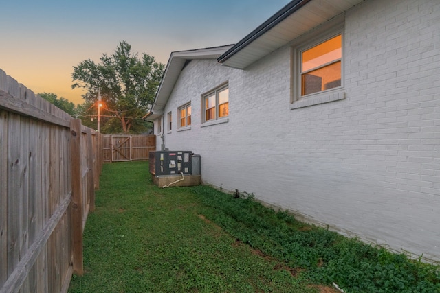 property exterior at dusk with a yard