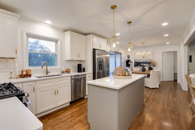 kitchen featuring white cabinetry, stainless steel appliances, dark hardwood / wood-style flooring, a kitchen island, and sink