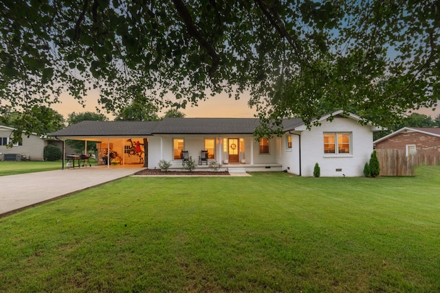 view of front of home with a porch and a lawn