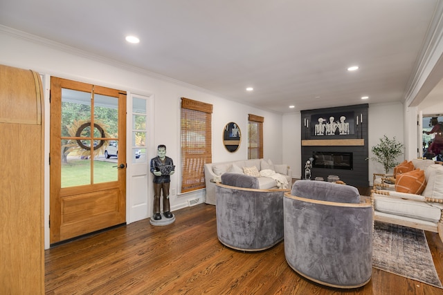 living room featuring a fireplace, ornamental molding, and dark hardwood / wood-style floors