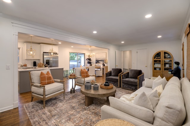 living room featuring ornamental molding, dark hardwood / wood-style floors, and a chandelier