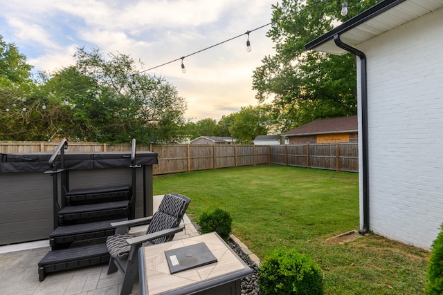 yard at dusk featuring a patio