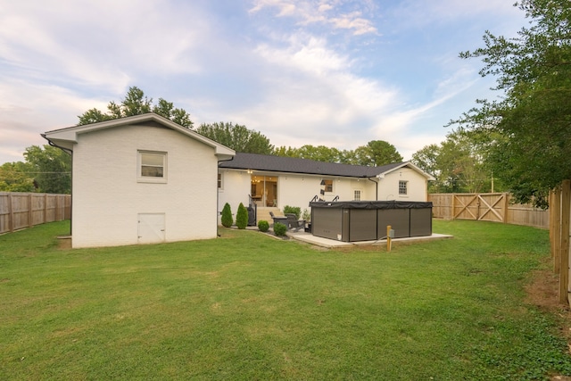 back of property featuring a lawn and a pool