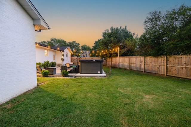 yard at dusk with a patio area