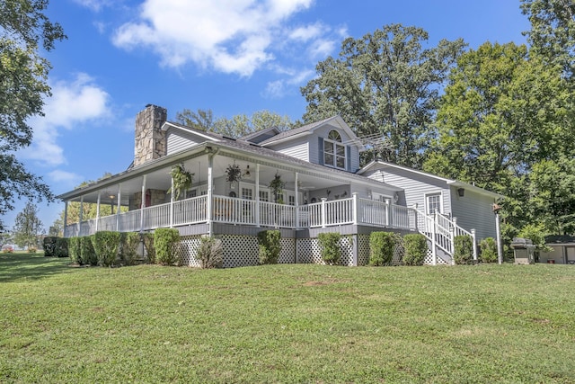 view of front of property featuring a front lawn, ceiling fan, and covered porch