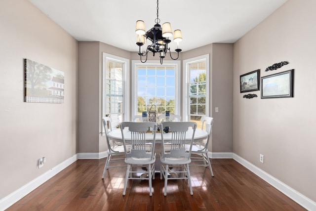 dining area featuring a chandelier and dark hardwood / wood-style floors