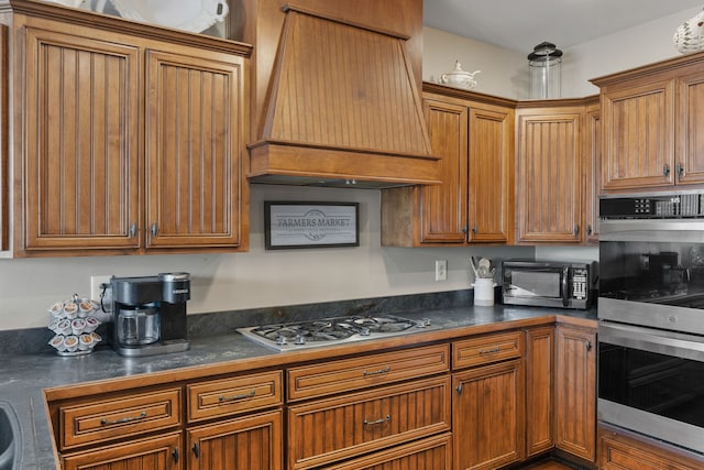 kitchen featuring premium range hood and stainless steel appliances