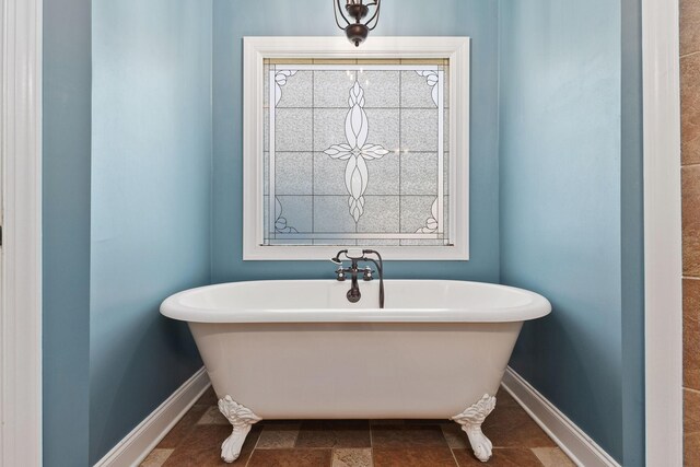 4584 S Mill Ln, Cross Plains, TN 37049 - bathroom with baseboards and a freestanding tub