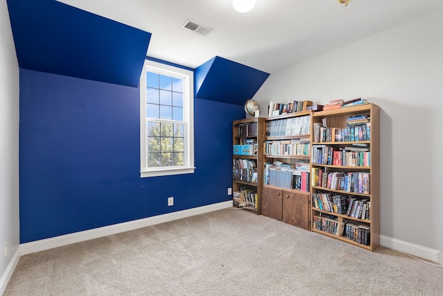 interior space featuring carpet and vaulted ceiling